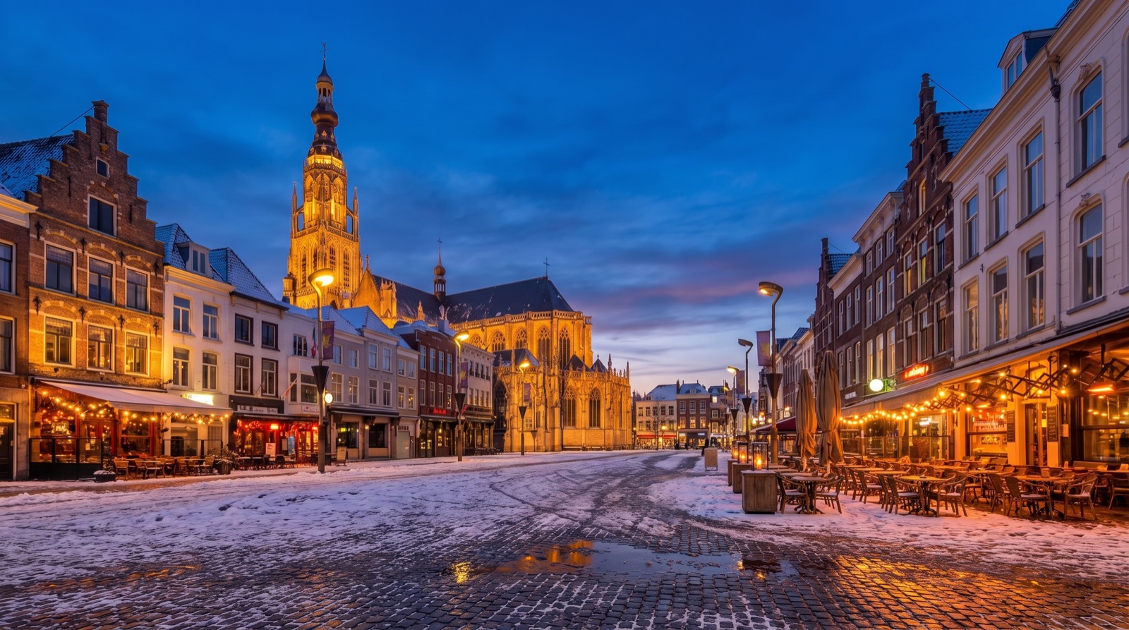 De Grote Markt in Breda bij avondlicht, met de Grote Kerk op de achtergrond
